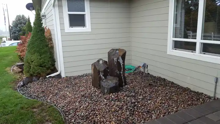 Three stepped basalt columns beside a house in rainbow river rock
