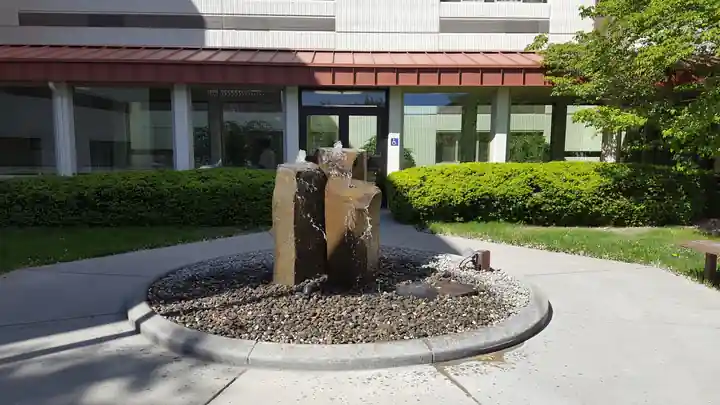 Basalt trio fountain in a planter ring outside a commercial building
