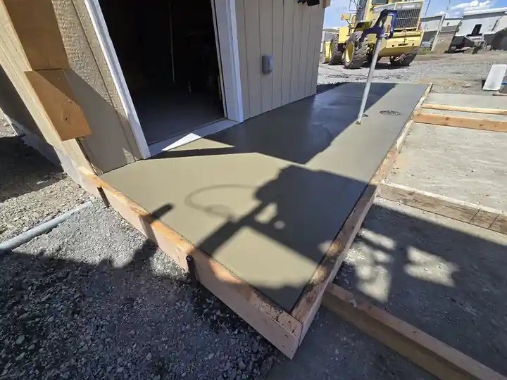 Fresh concrete in wooden forms at a garage door