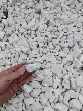 China White rock in a hand