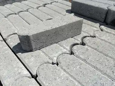 Grey edgestones stacked on a pallet in the yard