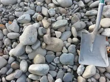 6 to 12 inch river rock with a shovel