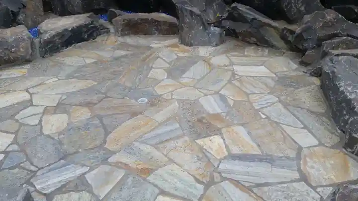 Finished flagstone sitting area edged with boulders