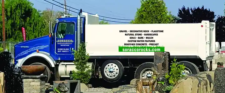 Blue Kenworth dump truck lettered soraccorocks.com parked at the yard